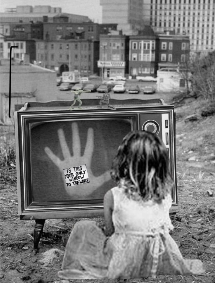 Girl looking at an old gray television screen